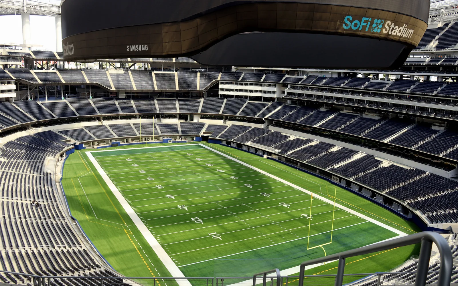 Exterior view of SoFi Stadium in Inglewood, a modern sports venue with curved architecture and contemporary design