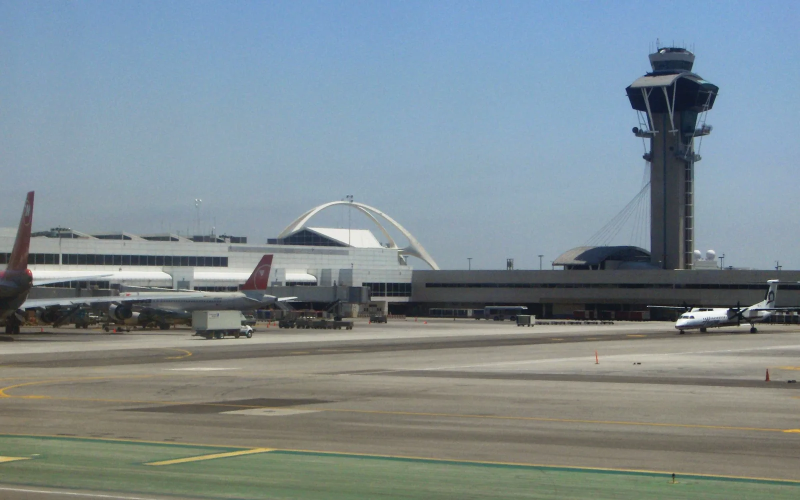 View of Los Angeles International Airport tarmac showing characteristic LAX buildings and the control tower, representing Inglewood's proximity to the airport